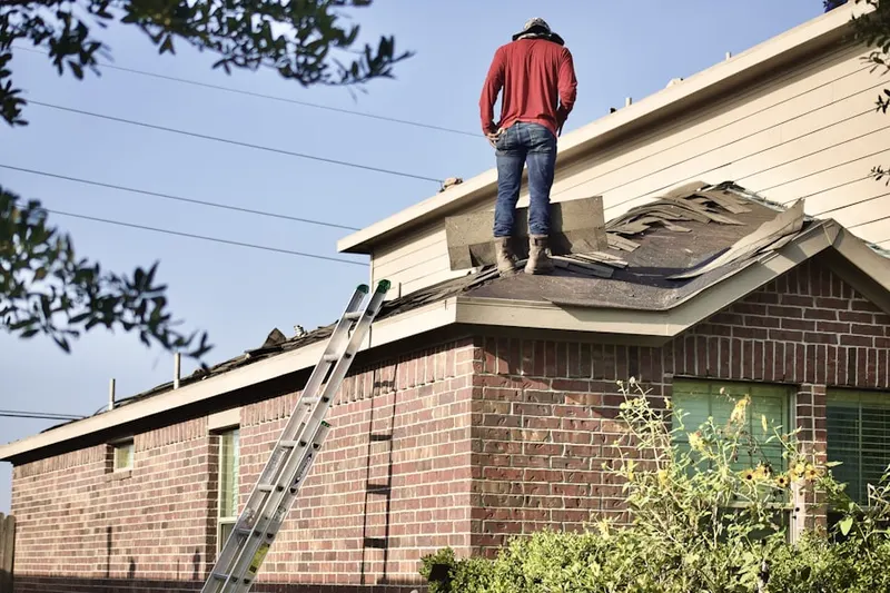 Professional roofer working on a residential roof in Twelve Bridges Village